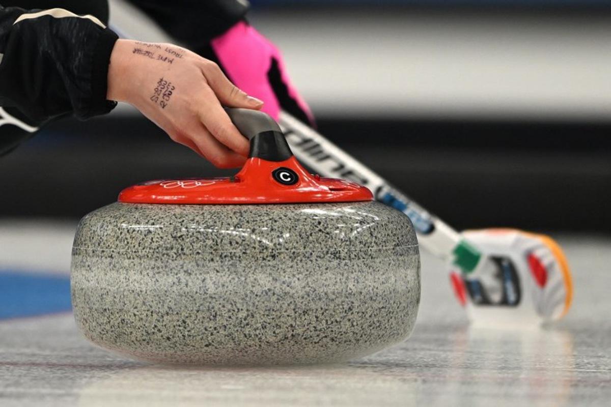 Japan's Satsuki Fujisawa curls the stone during the women's gold medal game of the Beijing 2022 Winter Olympic Games curling competition between Japan and Great Britain at the National Aquatics Centre in Beijing on February 20, 2022. Lillian SUWANRUMPHA / AFP