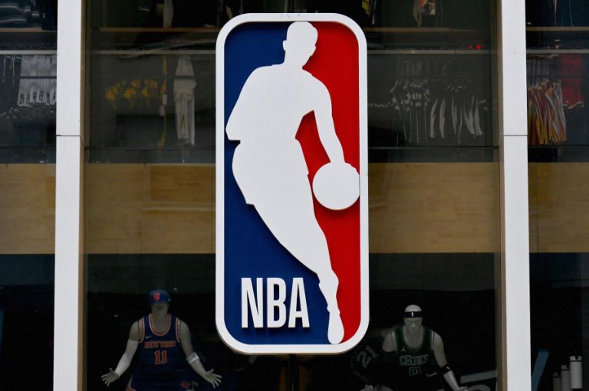 The NBA logo is seen outside an NBA fan store in New York on July 8, 2024. ANGELA WEISS / AFP