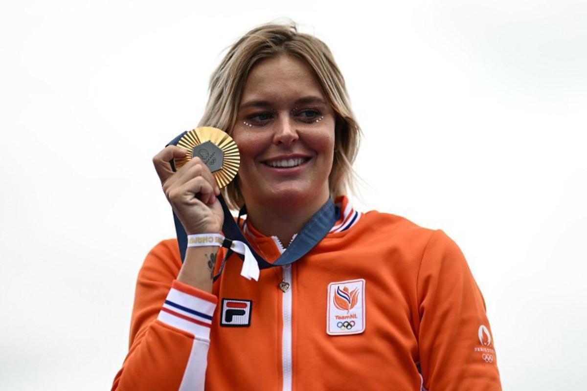 Netherlands' Sharon Van Rouwendaal, women's 10km marathon swimming gold medalist, celebrates on stage at the Champions Park at Trocadero during the Paris 2024 Olympic Games in Paris on August 9, 2024. CARL DE SOUZA / AFP