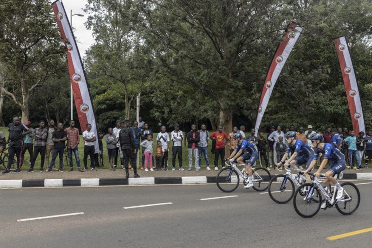 Residents gather to look at team Equipe continentale Groupama-FDJ team before the beginning of the final stage of the 16h Tour du Rwanda on 25 February 2024, in Kigali. Israel Premier Tech's British rider Joseph Blackmore, won the Tour of Rwanda which ended on Sunday in the capital Kigali. Guillem Sartorio / AFP