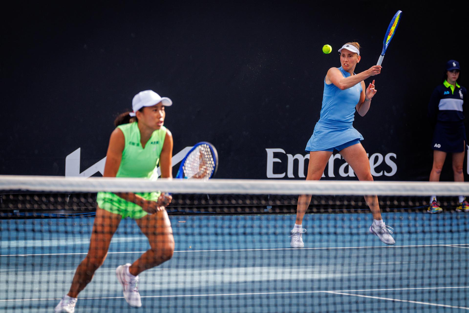 Belgian Elise Mertens (blue, R) and Chinese Zhang Shuai (green) pictured during a first round match of Belgium-China's Mertens-Shuai pair against Romania-Russia's pair Cirstea-Kalinskya in the women doubles at the Australian Open, Melbourne Park, Melbourne on Wednesday 21 January 2026. Mertens - Shuai won the game. BELGA PHOTO PATRICK HAMILTON --- BENELUX ONLY ---