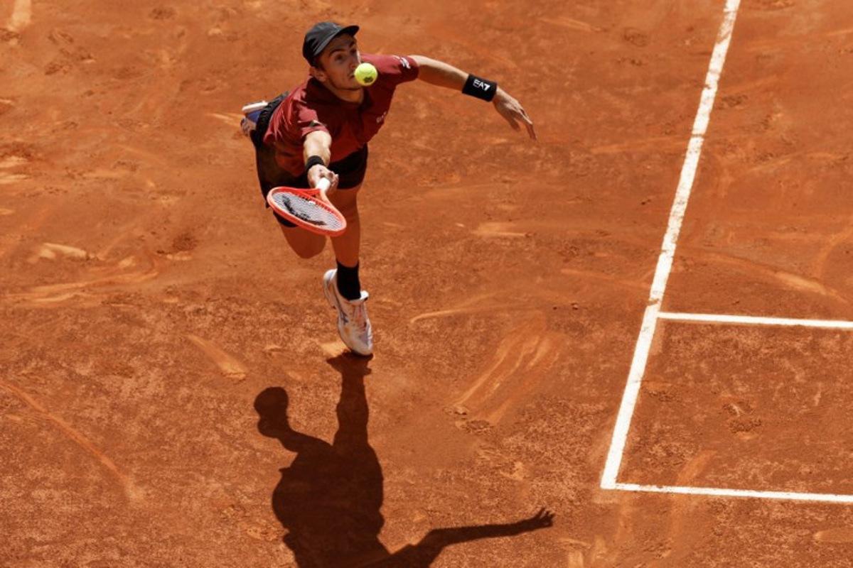 Italy's Matteo Arnaldi returns the ball to Serbia's Novak Djokovic during their 2025 ATP Tour Madrid Open tennis tournament second round singles match at the Caja Magica in Madrid, on April 26, 2025. OSCAR DEL POZO / AFP
