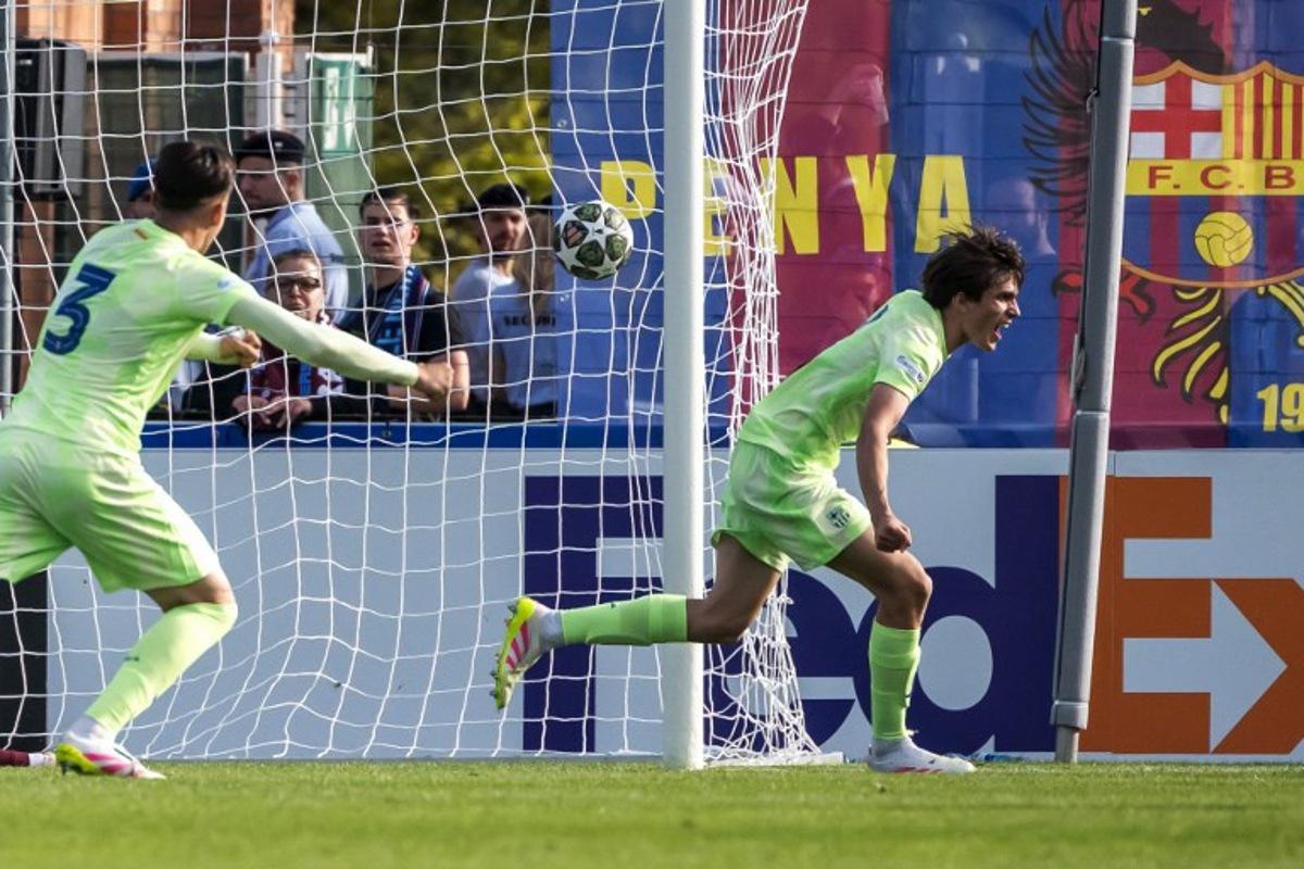 Barcelona's Spanish defender #4 Andres Cuenca (R) celebrates scoring his team's second goal next to teammate Swiss defender #3 Eman Kospo during the UEFA Youth League final football match between Trabzonspor AS and FC Barcelona at the Colovray Sport Center in Nyon, on April 28, 2025. Fabrice COFFRINI / AFP