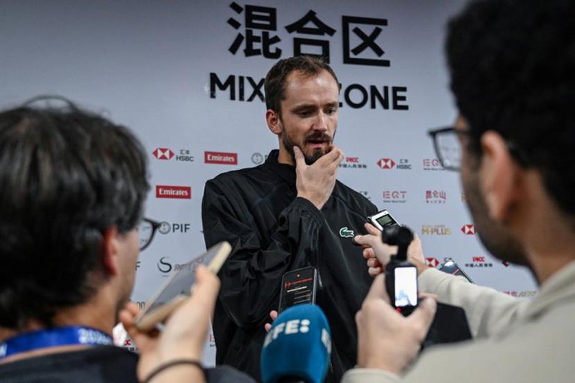 Russia's Daniil Medvedev (C) speaks to media after he was disqualified for hitting a ball into the stands, injuring a spectator, during the men's singles semi-final against Serbia's Novak Djokovic at the China Open tennis tournament in Beijing on October 5, 2026. GREG BAKER / AFP