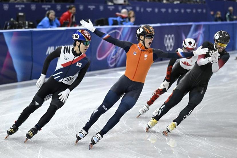 Netherlands' Jens van 't Wout (C) celebrates as he crosses the finish line to win gold in the short track speed skating men's 1500m final during the Milano Cortina 2026 Winter Olympic Games at Milano Ice Skating Arena in Milan on February 14, 2026. WANG Zhao / AFP