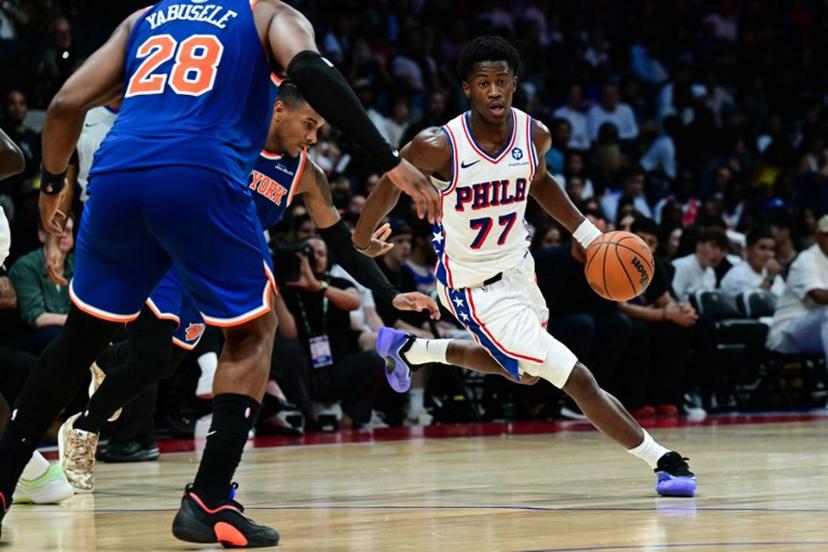 Philadelphia 76ers' #77 VJ Edgecombe dribbles the ball during the NBA basketball game between the New York Knicks and the Philadelphia 76ers at the Etihad Arena in Abu Dhabi on October 2, 2025. Giuseppe CACACE / AFP