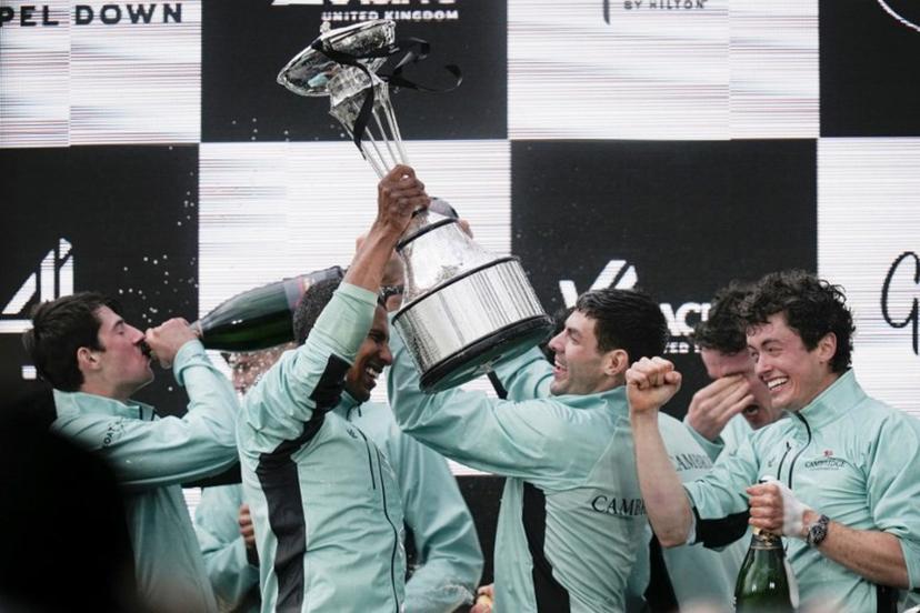 Cambridge's French president, Noam Mouelle celebrates lifts the trophy after winning the 171th men's boat race between Oxford University and Cambridge University on the River Thames in London on April 4, 2026. CARLOS JASSO / AFP