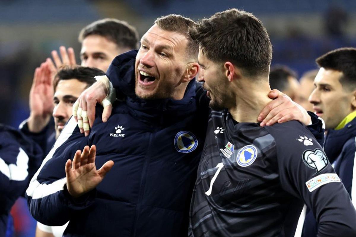 Bosnia-Herzegovina's forward Edin Dzeko (L) Bosnia-Herzegovina's goalkeeper Nikola Vasilj react after the FIFA World Cup qualification semi-final football match between Wales and Bosnia and Herzegovina, at Cardiff City Stadium, in Cardiff, on March 26, 2026. Darren Staples / AFP