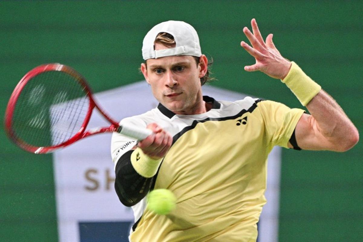 Belgium's Zizou Bergs hits a return to Spain's Carlos Alcaraz during their men's singles match at the Shanghai Masters tennis tournament in Shanghai on October 12, 2026. Hector RETAMAL / AFP