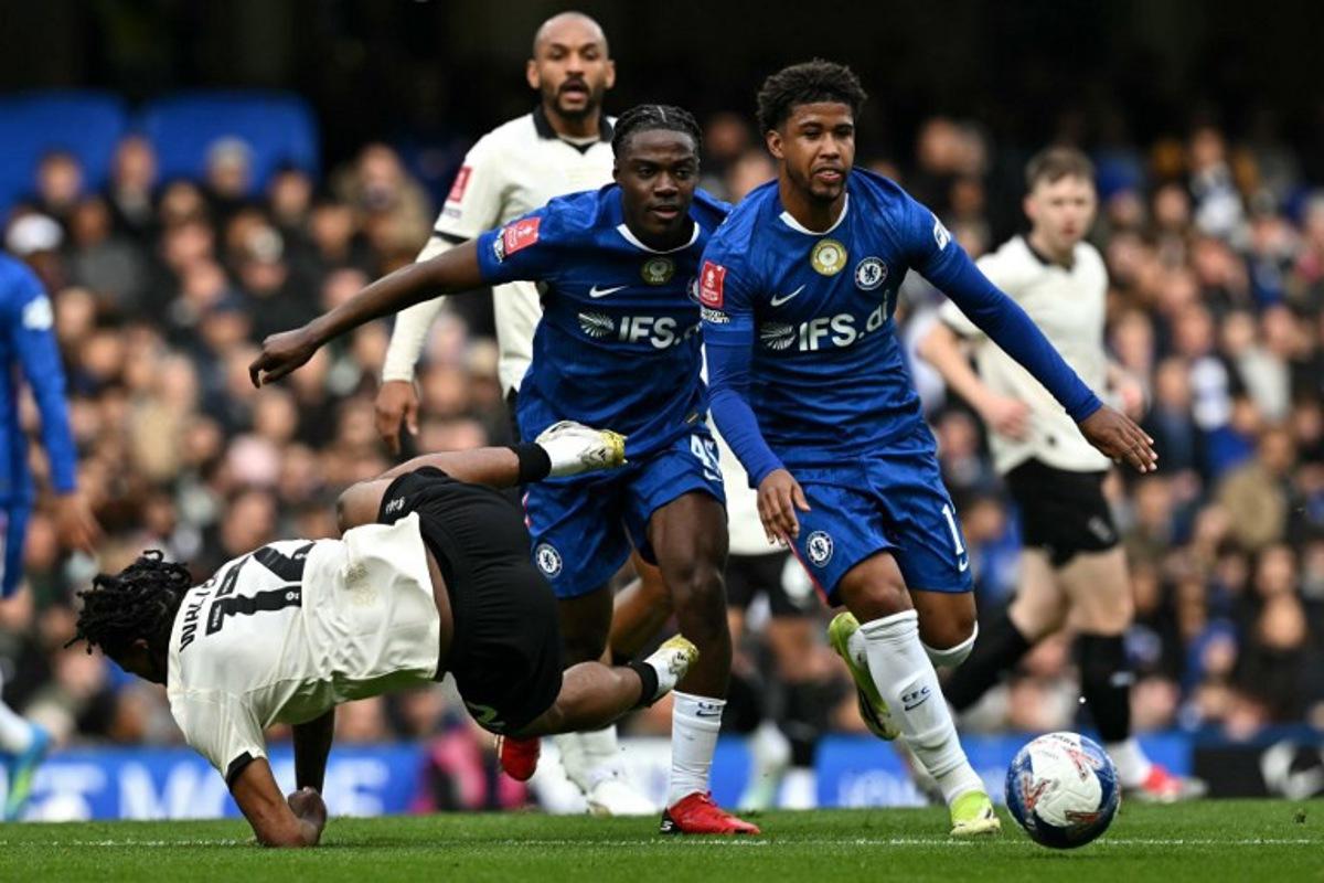 Port Vale's English midfielder #12 Rhys Walters is fouled by Chelsea's Belgian midfielder #45 Romeo Lavia and Chelsea's Brazilian midfielder #17 Andrey Santos (R) during the English FA Cup quarter final football match between Chelsea and Port Vale at Stamford Bridge in London on April 4, 2026. Ben STANSALL / AFP
