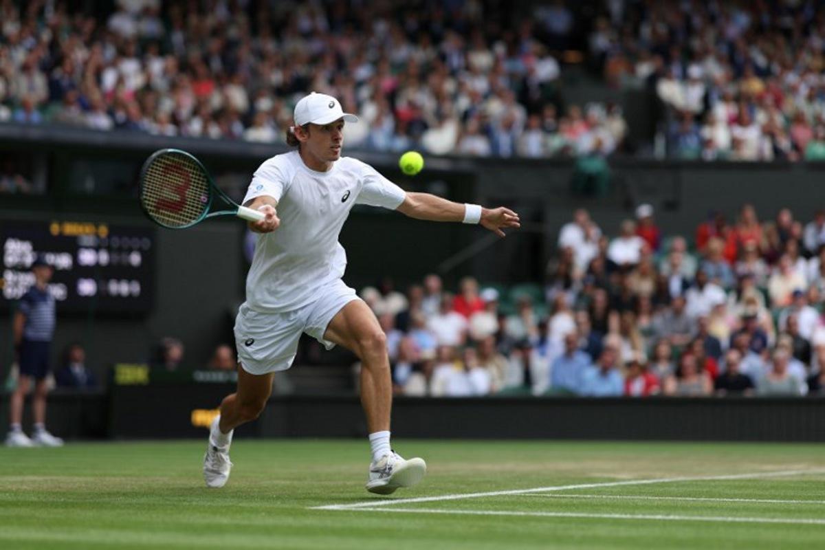 Australia's Alex De Minaur plays a forehand return to Serbia's Novak Djokovic during their men's singles fourth round tennis match on the eighth day of the 2025 Wimbledon Championships at The All England Lawn Tennis and Croquet Club in Wimbledon, southwest London, on July 7, 2025. Adrian Dennis / AFP