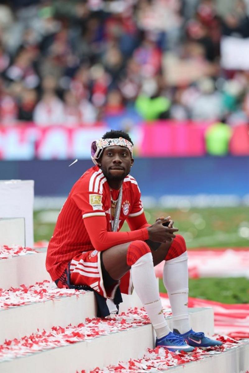 Bayern Munich's Canadian defender #19 Alphonso Davies sits on the stairs during celebrations for the Bundesliga trophy after wining the German first division Bundesliga football match between FC Bayern Munich and FC Cologne in Munich, southern Germany, on May 16, 2026. Alexandra BEIER / AFP