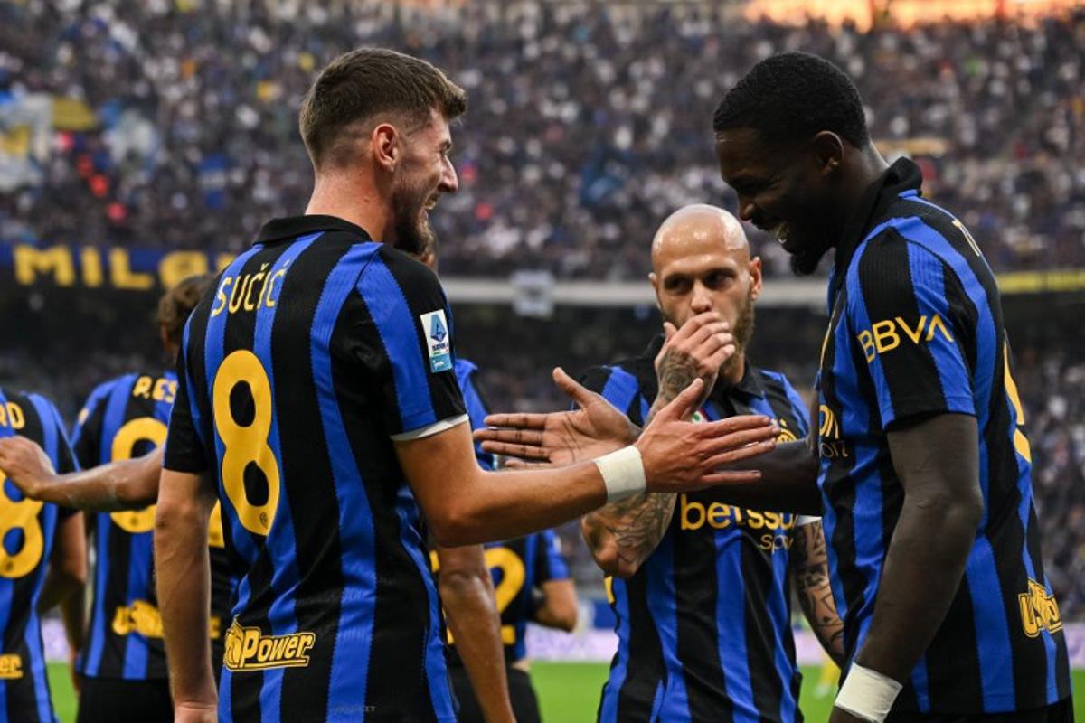 Inter Milan's Croatian midfielder #8 Petar Sucic (L) celebrates with teammates after scoring a goal during the Italian Serie A football match between Inter Milan and Parma at the San Siro Stadium in Milan, on October 10, 2026. Piero CRUCIATTI / AFP
