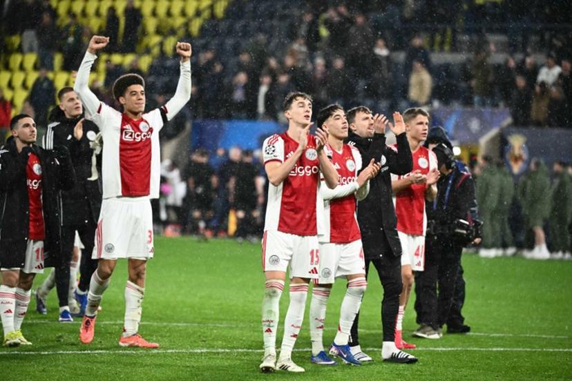 Ajax's Dutch defender #15 Youri Baas and teammates celebrate with supporters after winning the UEFA Champions League league phase day 7 football match between Villarreal CF and Ajax at La Ceramica Stadium in Vila-real on January 20, 2026. JOSE JORDAN / AFP