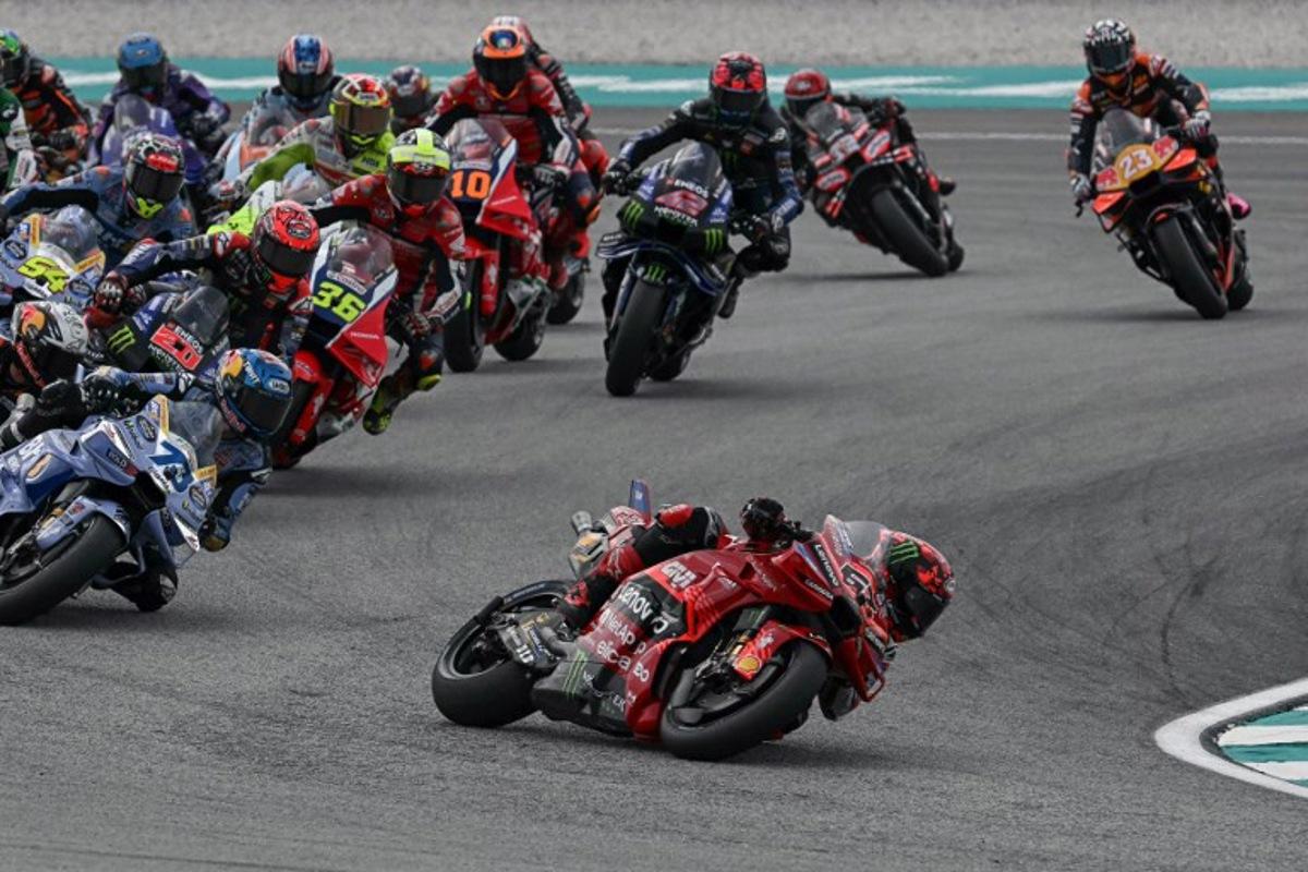 Ducati Lenovo Team's Italian MotoGP rider Francesco Bagnaia (C) leads in the Sprint race of the MotoGP Malaysian Grand Prix at the Sepang International Circuit in Sepang on October 25, 2025. Lillian SUWANRUMPHA / AFP