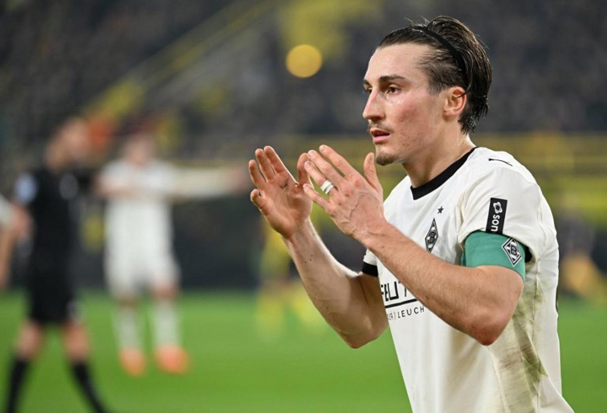 Moenchengladbach's German midfielder #27 Rocco Reitz reacts during the German first division Bundesliga football match between Borussia Dortmund and Borussia Moenchengladbach in Dortmund on December 19, 2025. UWE KRAFT / AFP