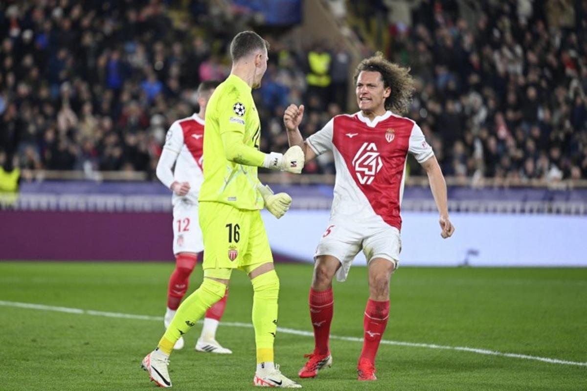 Monaco's Belgian defender #25 Wout Faes reacts after Monaco's Swiss goalkeeper #16 Philipp Kohn (L) stopped a penalty during the UEFA Champions League knockout round play-off first leg football match between AS Monaco and Paris Saint-Germain at the Stade Louis II in the Principality of Monaco on February 17, 2026. Frederic Dides / AFP