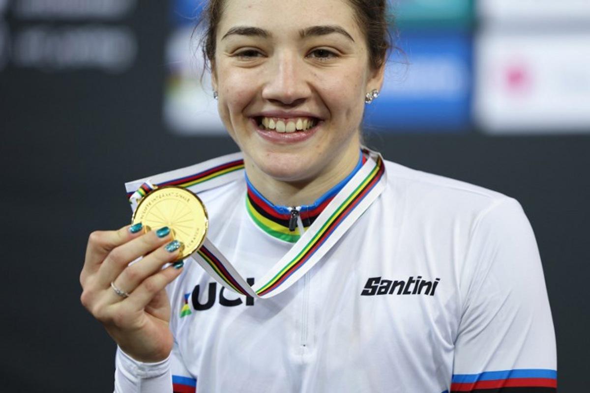 Italy's Martina Fidanza celebrates with her gold medal on the podium after winning the Women's 10 km Scratch Race final during the UCI Track Cycling World Championships at the Velodrome of Saint-Quentin-en-Yvelines, southwest of Paris, on October 12, 2022. Thomas SAMSON / AFP