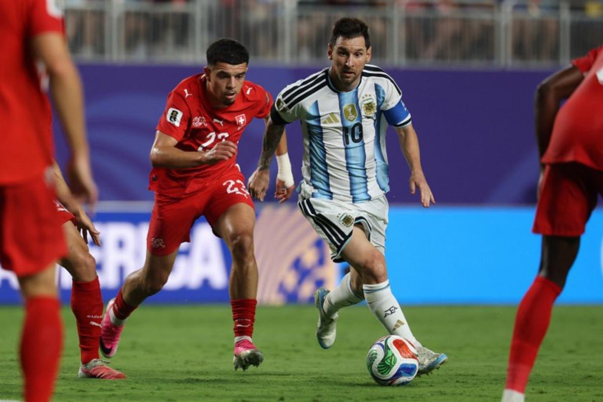 Argentina's forward #10 Lionel Messi runs with the ball followed by Switzerland's forward #23 Zeki Amdouni during the 2026 World Cup football tournament quarter-final match between Argentina and Switzerland at the Kansas City Stadium in Kansas City on July 11, 2026. Odd ANDERSEN / AFP