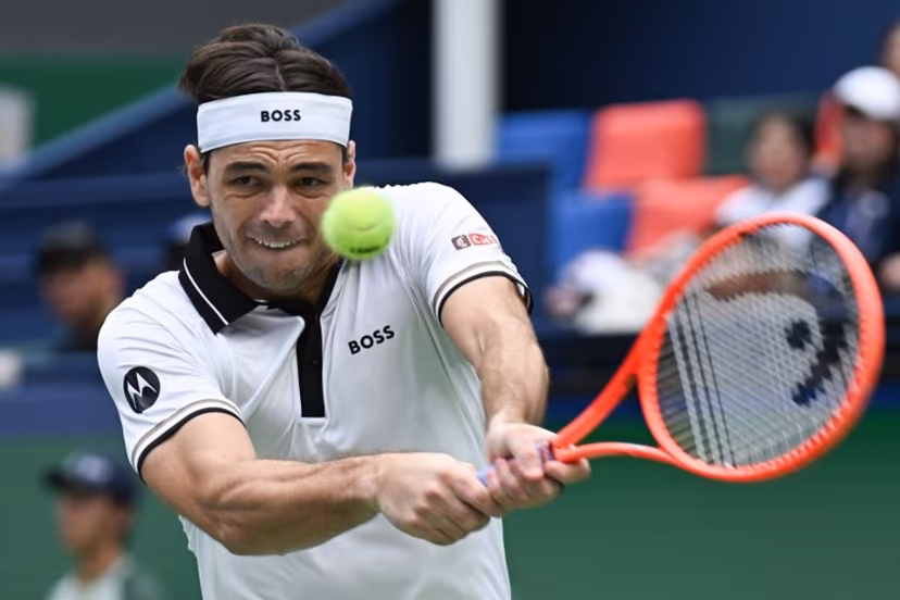 USA's Taylor Fritz hits a return to Greece's Stefanos Tsitsipas during their men's singles match at the Shanghai Masters tennis tournament in Shanghai on October 12, 2026. CN-STR / AFP