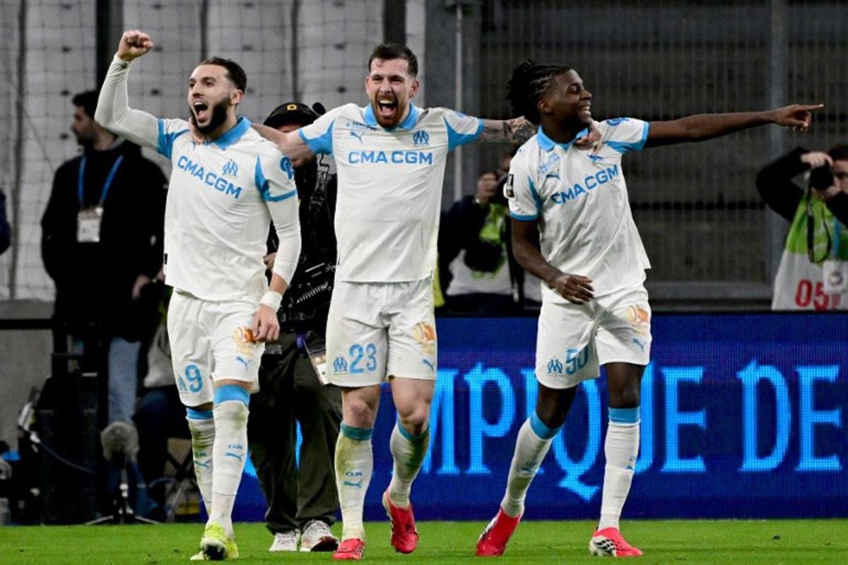 Marseille's Algerian forward #09 Amine Gouiri (L) celebrates with Marseille's Danish midfielder #23 Pierre-Emile Hojbjerg (C) and Marseille's French midfielder #50 Darryl Bakola (R) after scoring a goal during the French L1 football match between Olympique de Marseille (OM) and RC Lens at the Stade Velodrome in Marseille, southern France, on January 24, 2026. Miguel MEDINA / AFP