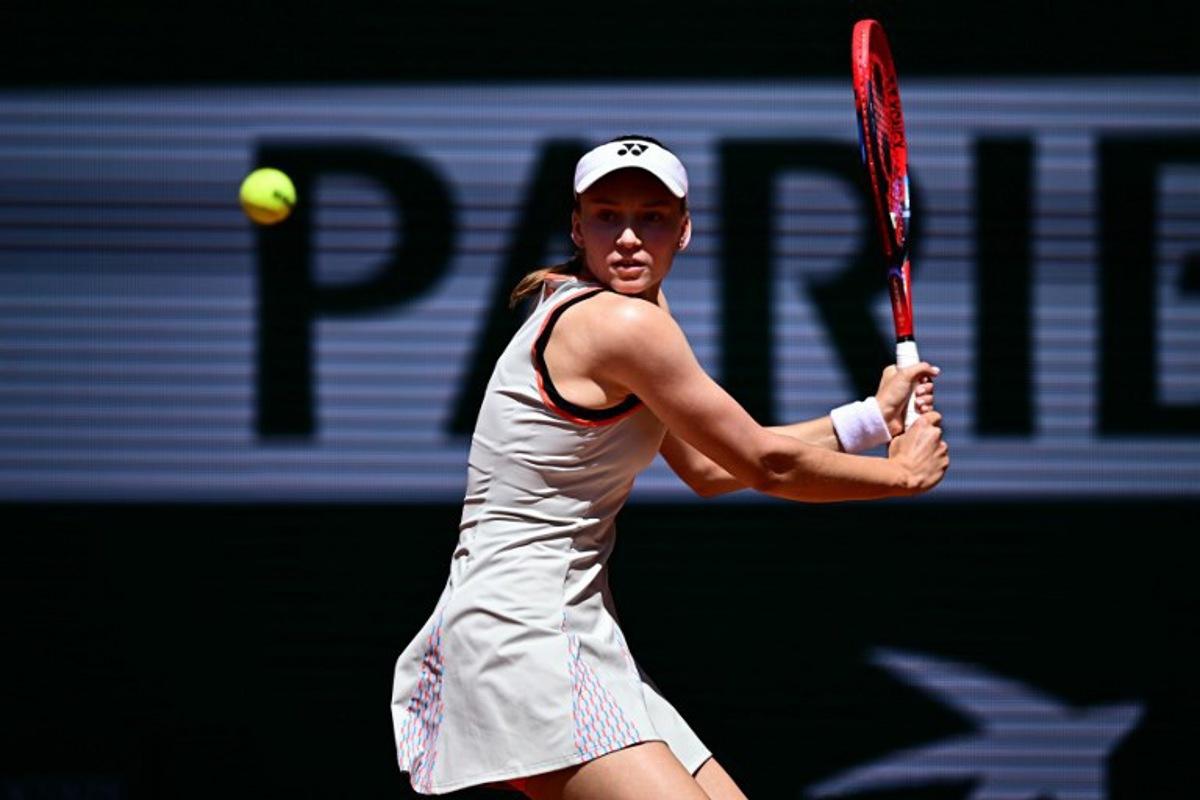 Kazakhstan's Elena Rybakina plays a backhand return to Slovenia's Veronika Erjavec during their women's singles match on day 2 of the French Open tennis tournament on Court Philippe-Chatrier at the Roland-Garros Complex in Paris on May 25, 2026. JULIEN DE ROSA / AFP