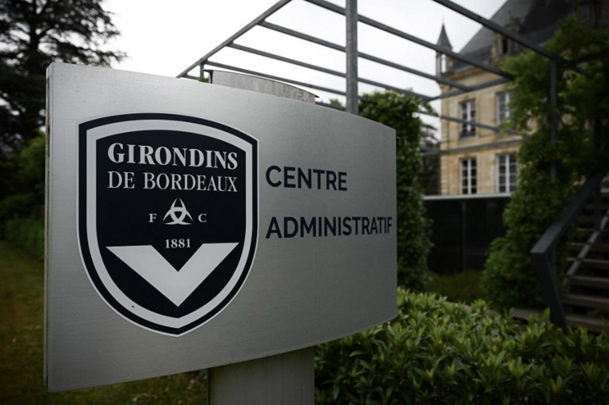 This general view taken on May 19, 2022, shows a sign with a logo in front of the chateau of FC Girondins de Bordeaux at the club's training ground in Le Haillan, near Bordeaux, south-western France. Philippe LOPEZ / AFP
