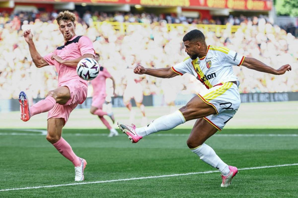 Lens' French defender Matthieu Udol (R) kicks the ball next to Sunderland's Belgian defender Thomas Meunier during a friendly football match between RC Lens and AFC Sunderland at the Bollaert-Delelis Stadium in Lens, northern France, on August 8, 2026. Sameer Al-DOUMY / AFP