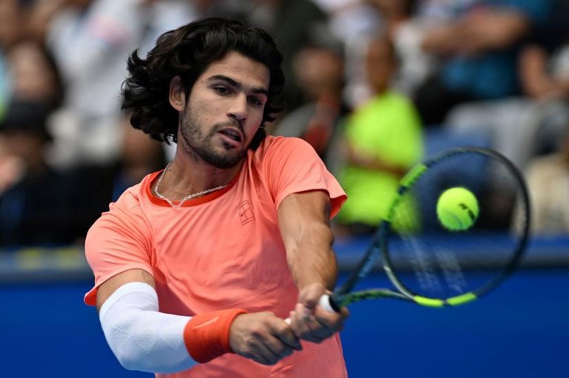 Spain's Carlos Alcaraz hits a return against Canada's Denis Shapovalov during their men's singles quarter-final tennis match at the ATP Tour Japan Open Tennis Championships at the Ariake Tennis Forest Park in Tokyo on October 4, 2026. Rie KIKUCHI / AFP