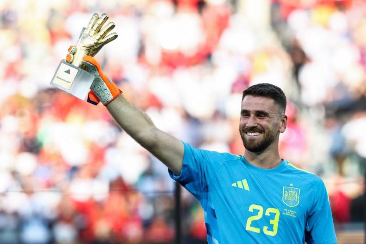 Spain's goalkeeper #23 Unai Simon receives the Golden Glove Award during the award ceremony of the 2026 World Cup football tournament final match between Spain and Argentina at the New York/New Jersey Stadium in East Rutherford on July 19, 2026. FRANCK FIFE / AFP