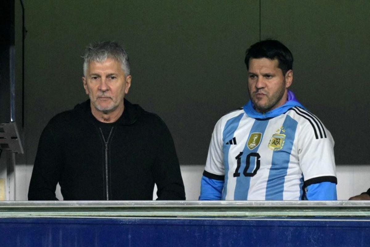 Argentina's forward Lionel Messi's father, Jorge Messi (L), and brother Rodrigo wait for the start of the 2026 FIFA World Cup South American qualifiers football match between Argentina and Peru at the La Bombonera stadium in Buenos Aires on November 19, 2024. JUAN MABROMATA / AFP