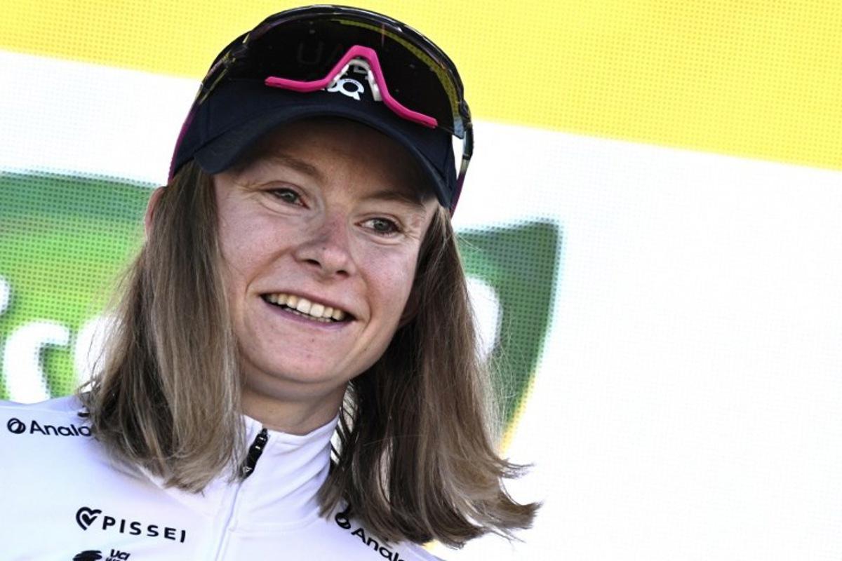 UAE Team ADQ's French rider Maeva Squiban celebrates her combativity award on the podium after winning the 7th stage (out of 9) of the fourth edition of the Women's Tour de France cycling race, 159.7 km from Bourg-en-Bresse to Chambéry, in Chambéry, south-eastern France on August 1, 2025. JULIEN DE ROSA / AFP