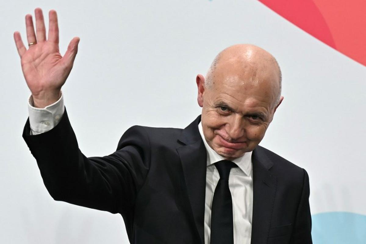German Football Association (DFB) president Bernd Neuendorf waves to the audience after Germany was elected to host the UEFA Women's EURO 2029 fooball tournament during an announcement ceremony at the UEFA headquarters, the House of European Football, in Nyon on December 3, 2025. European football's governing body UEFA announced on December 3, 2025 that Germany will host the women's 2029 European Championships, where England will be the two-time defending champions. Fabrice COFFRINI / AFP