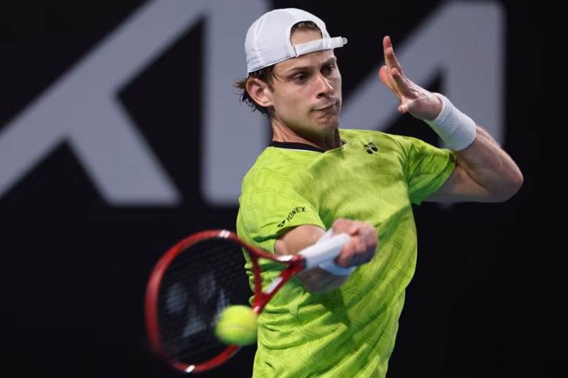 Belgium's Zizou Bergs hits a shot against Poland's Hubert Hurkacz during their men's singles match on day three of the Australian Open tennis tournament in Melbourne on January 20, 2026. IZHAR KHAN / AFP