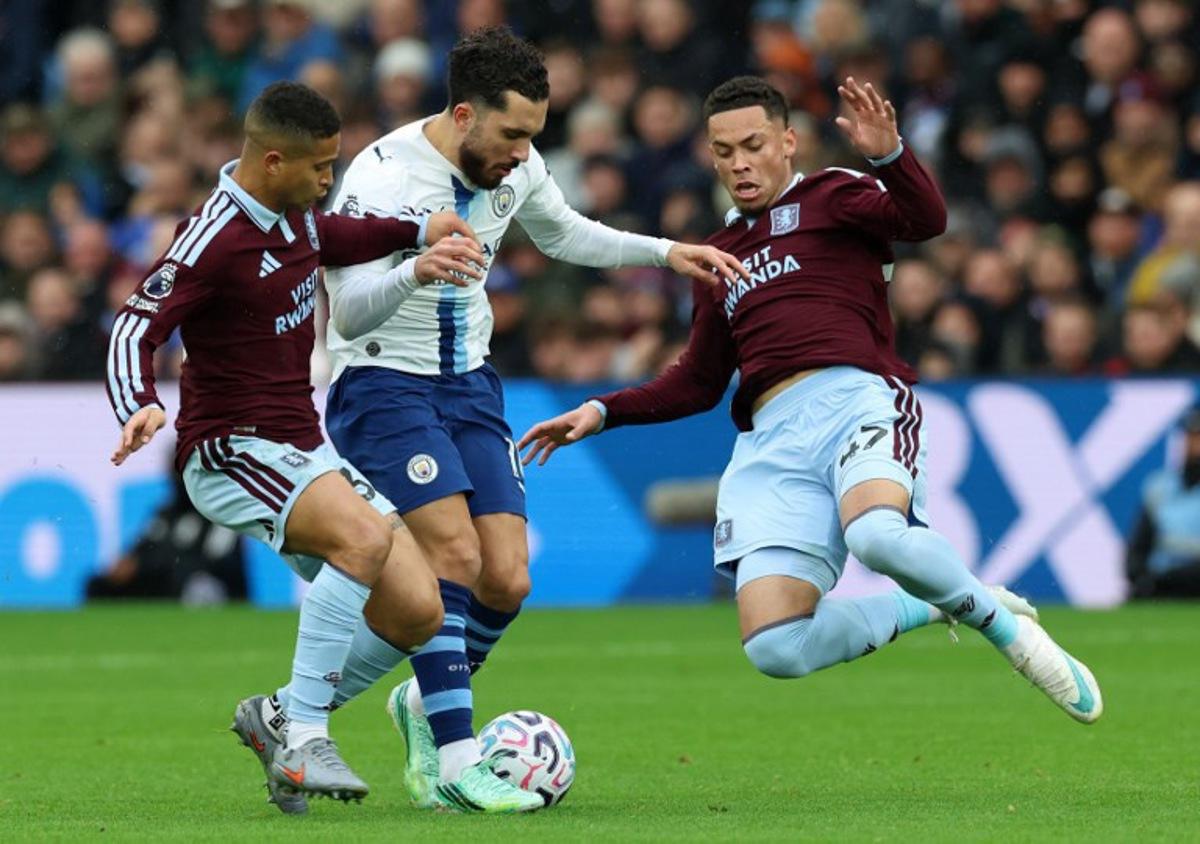 Aston Villa's Brazilian striker #47 Alysson (R) dives to tackle Manchester City's French midfielder #10 Rayan Cherki during the English Premier League football match between Aston Villa and Manchester City at Villa Park in Birmingham, central England on October 24, 2026. Darren Staples / AFP