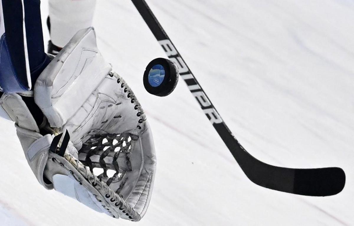 Finland's goaltender Harri Sateri catches the puck during the men's play-off quarterfinal match of the Beijing 2022 Winter Olympic Games ice hockey competition against Switzerland, at the National Indoor Stadium in Beijing on February 16, 2022. ANTHONY WALLACE / AFP