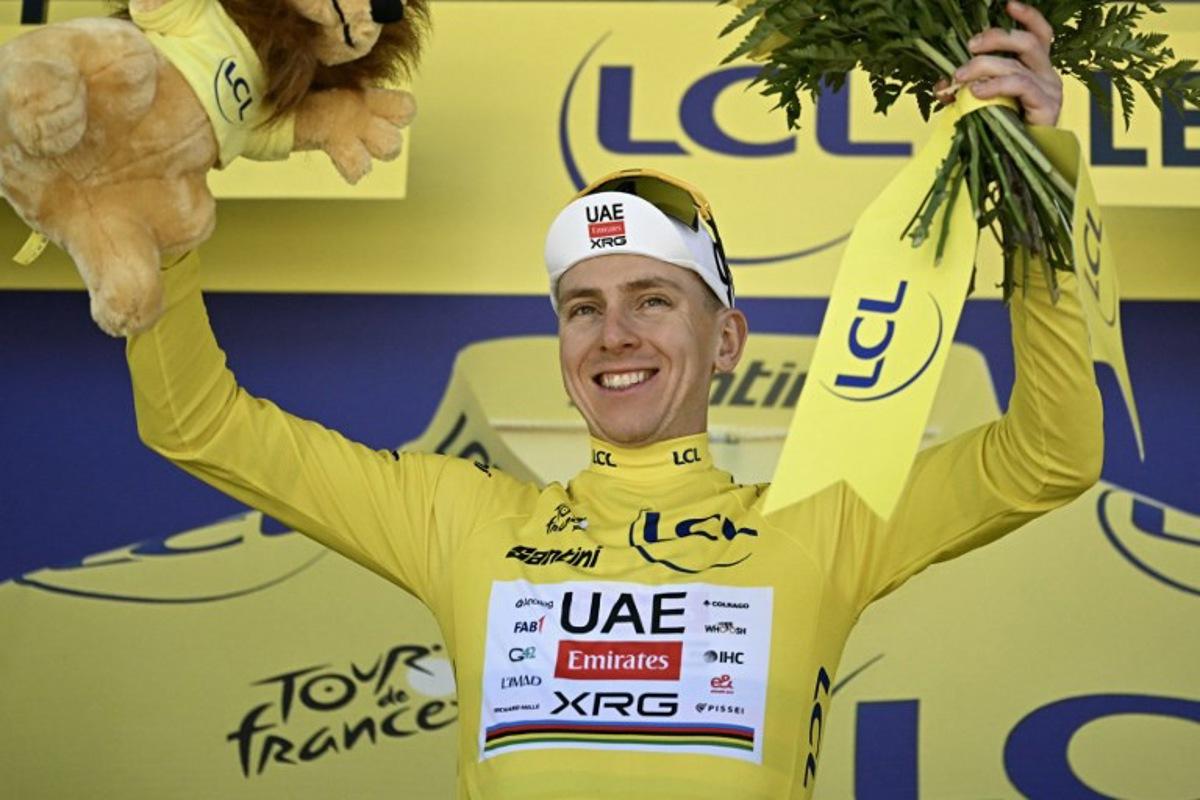 UAE Team Emirates - XRG's Slovenian rider Tadej Pogacar celebrates on the podium with the overall leader's yellow jersey after the 3rd stage of the 113th edition of the Tour de France cycling race, 196 km between Granollers and Les Angles in southern France, on July 6, 2026. Loic VENANCE / AFP