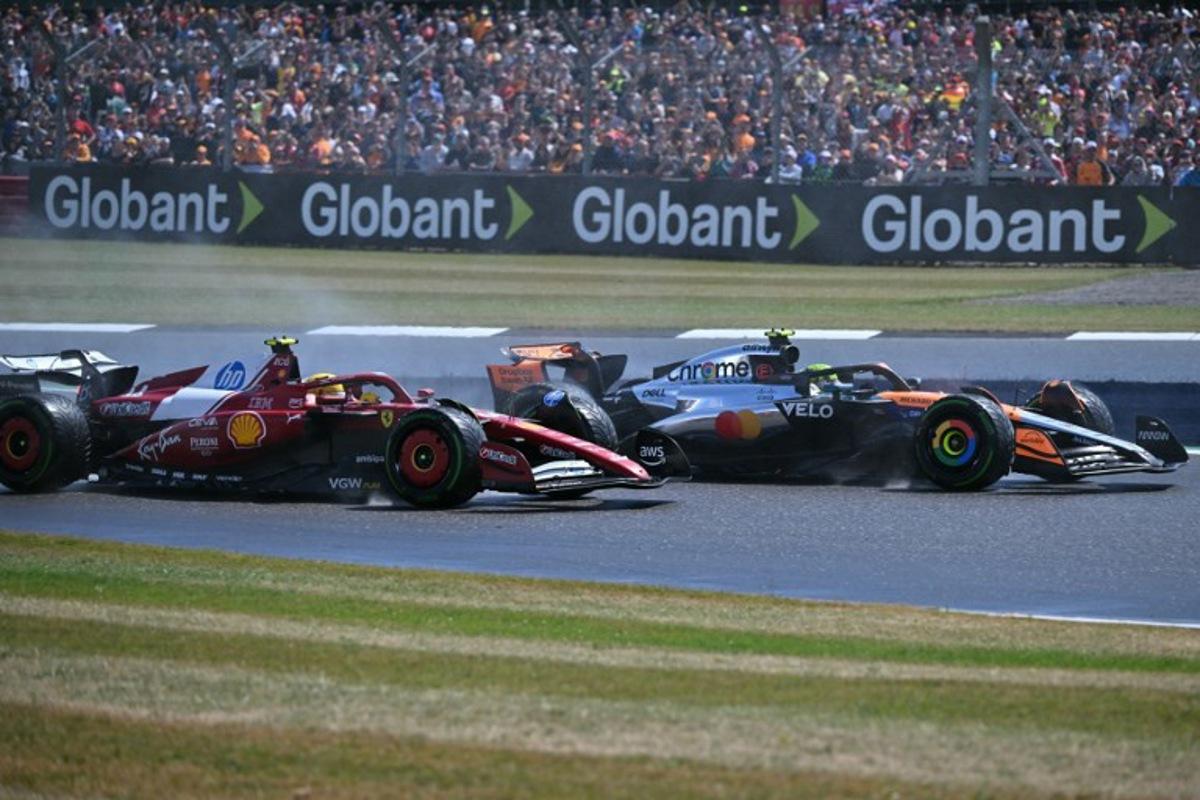 Ferrari's British driver Lewis Hamilton (L) challenges McLaren's British driver Lando Norris (R) on the first lap of the Formula One British Grand Prix at the Silverstone motor racing circuit in Silverstone, central England, on July 6, 2025. Andrej ISAKOVIC / AFP