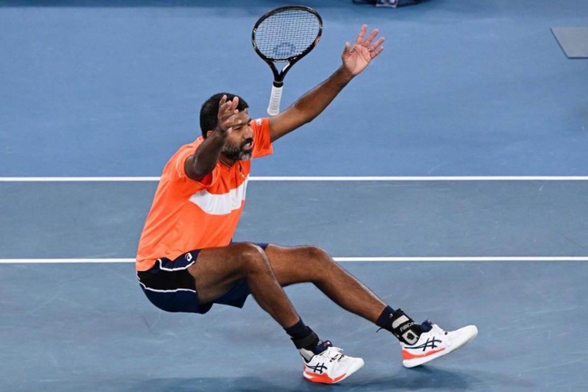 India's Rohan Bopanna celebrates after victory against Italy's Simone Bolelli and Andrea Vavassori during their men's doubles final match on day 14 of the Australian Open tennis tournament in Melbourne on January 27, 2024. WILLIAM WEST / AFP