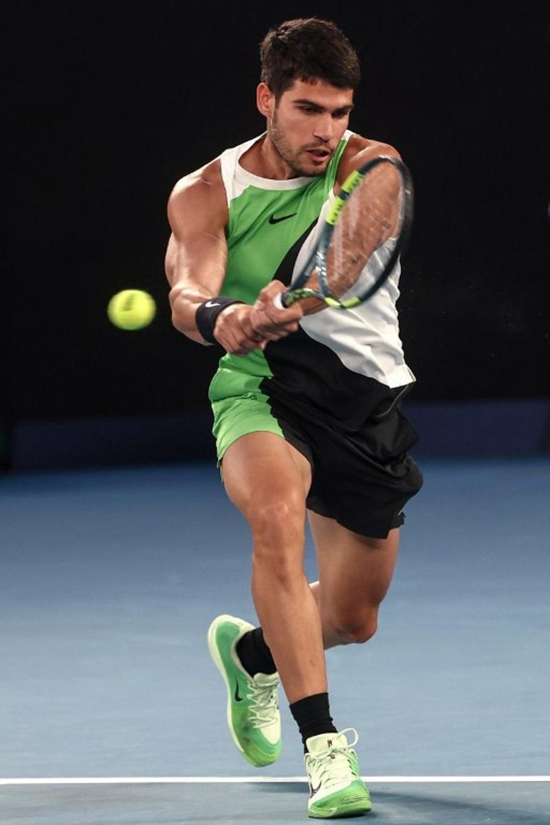 Spain's Carlos Alcaraz hits a return to Australia's Alex De Minaur during their men's singles quarter-final match on day ten of the Australian Open tennis tournament in Melbourne on January 27, 2026. IZHAR KHAN / AFP