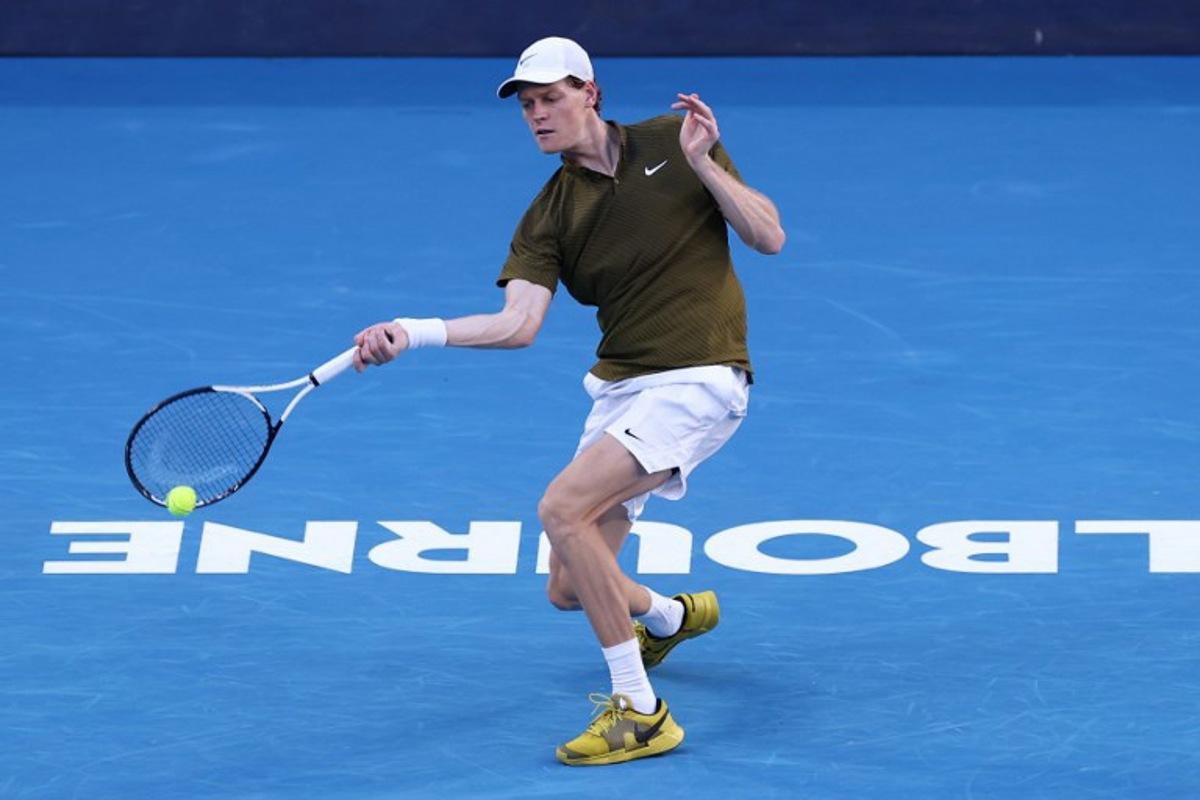 Italy's Jannik Sinner hits a shot against Italy's Luciano Darderi during their men's singles match on day nine of the Australian Open tennis tournament in Melbourne on January 26, 2026. IZHAR KHAN / AFP