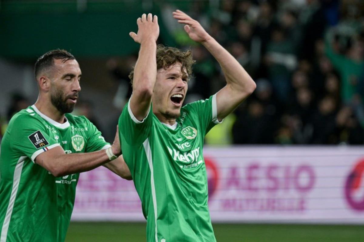 Saint-Etienne's Belgian forward #32 Lucas Stassin (R) celebrates after scoring a goal during the French L1 football match between AS Saint-Etienne and Olympique Lyonnais (OL) at the Geoffroy-Guichard Stadium in Saint-Etienne, central France on April 20, 2025. JEAN-PHILIPPE KSIAZEK / AFP