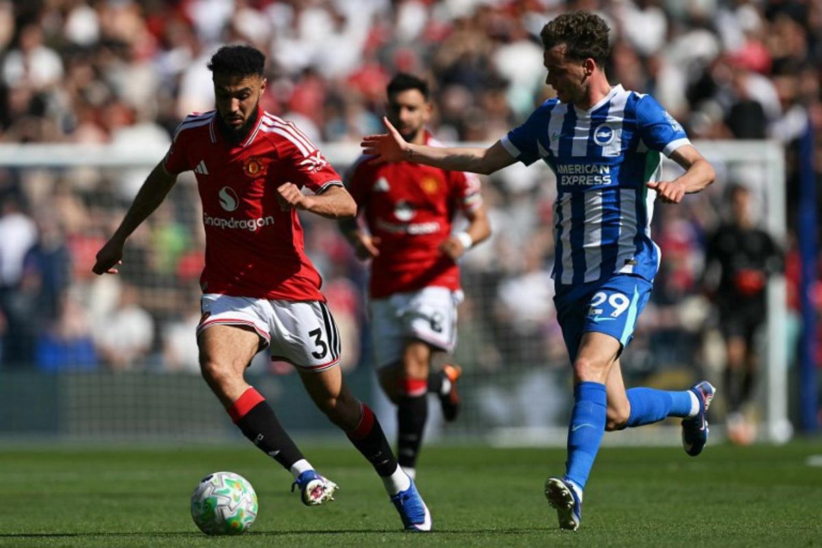 Manchester United's Moroccan defender #03 Noussair Mazraoui (L) vies for the ball with Brighton's Belgian defender #29 Maxim De Cuyper (R) during the English Premier League football match between Brighton and Hove Albion and Manchester United at the American Express Community Stadium in Brighton, southern England on May 24, 2026. Glyn KIRK / AFP