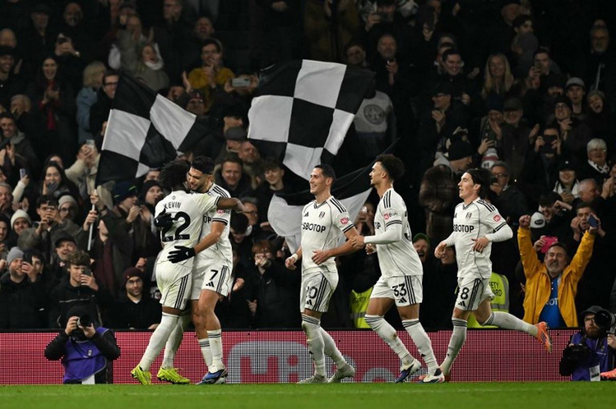 Fulham's Mexican striker #07 Raul Jimenez (2L) celebrates scoring the opening goal during the English Premier League football match between Fulham and Nottingham Forest at Craven Cottage in London on December 22, 2025. Ben STANSALL / AFP