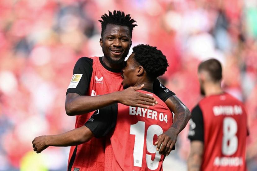 Bayer Leverkusen's English midfielder #19 Nathan Tella (front) celebrates the opening goal with team mate Bayer Leverkusen's Nigerian forward #22 Victor Boniface during the German first division Bundesliga football match between Bayer 04 Leverkusen and FC Augsburg in Leverkusen, western Germany on April 26, 2025. INA FASSBENDER / AFP