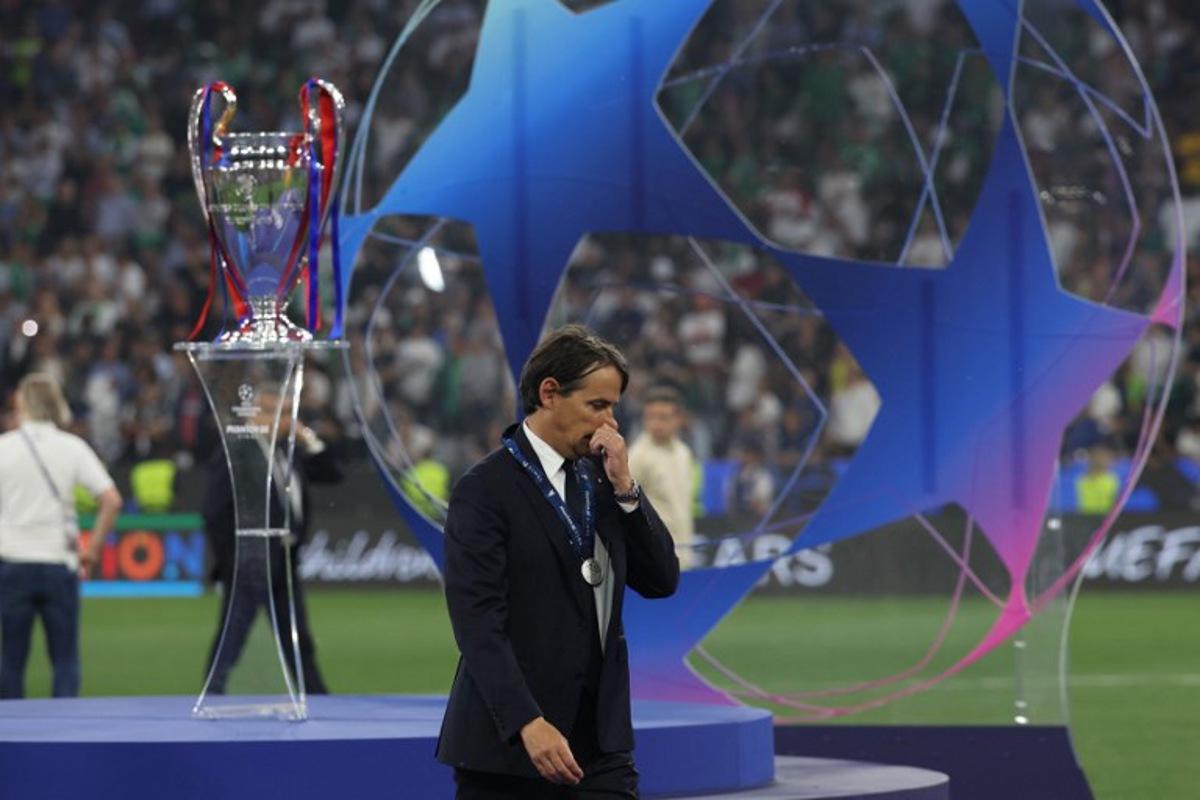 Inter Milan's Italian coach Simone Inzaghi reacts as he walks past the UEFA Champions League trophy at the end of the UEFA Champions League final football match between Paris Saint-Germain (PSG) and Inter Milan in Munich, southern Germany, on May 31, 2025. FRANCK FIFE / AFP