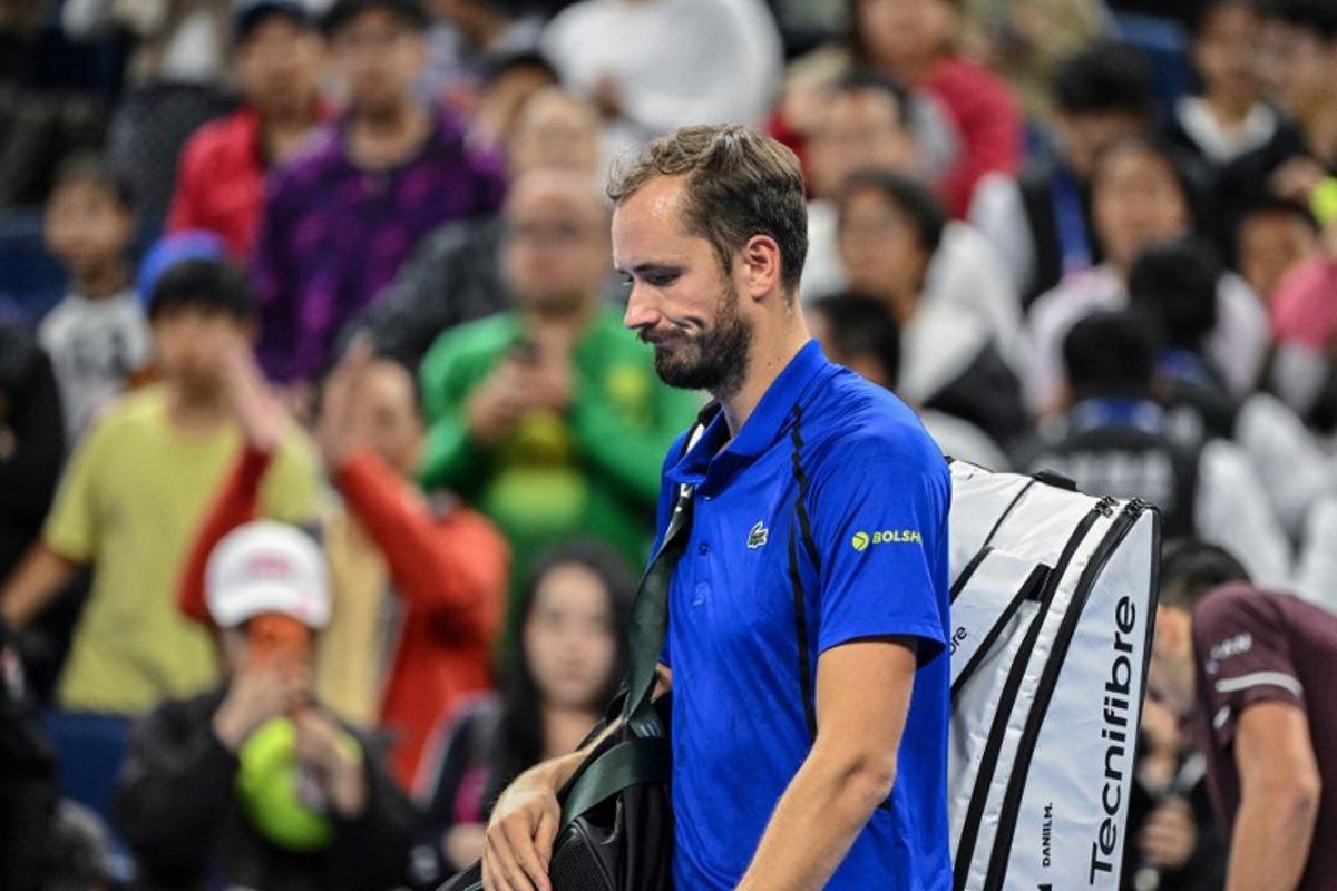Russia's Daniil Medvedev walks off the court after being disqualified for hitting a ball into the stands, injuring a spectator, during the men's singles semi-final against Serbia's Novak Djokovic at the China Open tennis tournament in Beijing on October 5, 2026. GREG BAKER / AFP