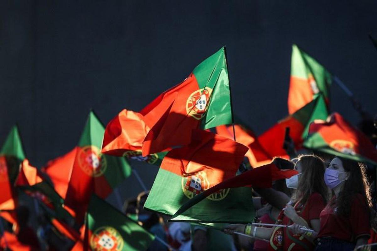 Supporters wave flags of Portugal during the FIFA World Cup Qatar 2022 European qualifying round group A football match between Portugal and Republic of Ireland at the Algarve stadium in Loule, near Faro, southern Portugal, on September 1, 2021. CARLOS COSTA / AFP