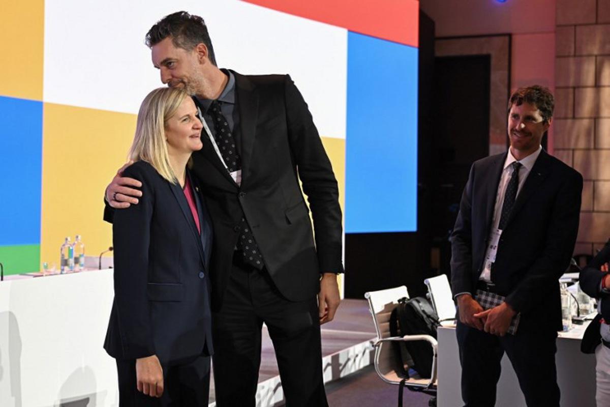 Zimbabwean candidate for the presidency of the International Olympic Committee (IOC) Kirsty Coventry (L) is congratulated by Former Spanish basketball player Pau Gasol (C) after being elected during the 144th IOC Session on the day of the election of the next President of the International Olympic Committee (IOC), in Costa Navarino, Greece on March 20, 2025. Zimbabwe's Kirsty Coventry was elected president of International Olympic Committee on March 20, 2025. Fabrice COFFRINI / AFP