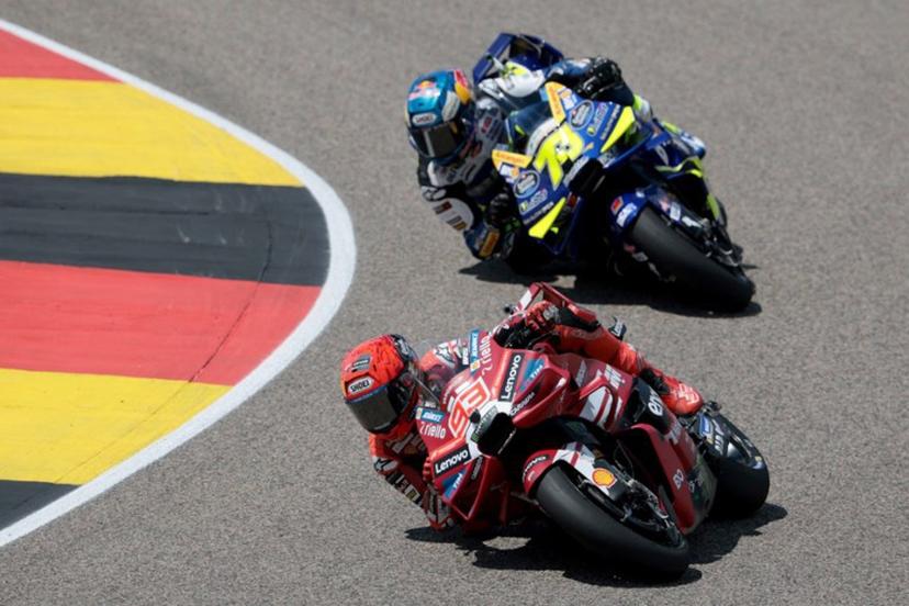 Ducati Lenovo Team's Spanish driver Marc Marquez (front) and BK8 Gresini Racing Team's Spanish driver Alex Marquez race during the German Motorcycle MotoGP Grand Prix at the Sachsenring race track in Hohenstein-Ernstthal near Chemnitz, eastern Germany, on July 12, 2026. Ronny HARTMANN / AFP